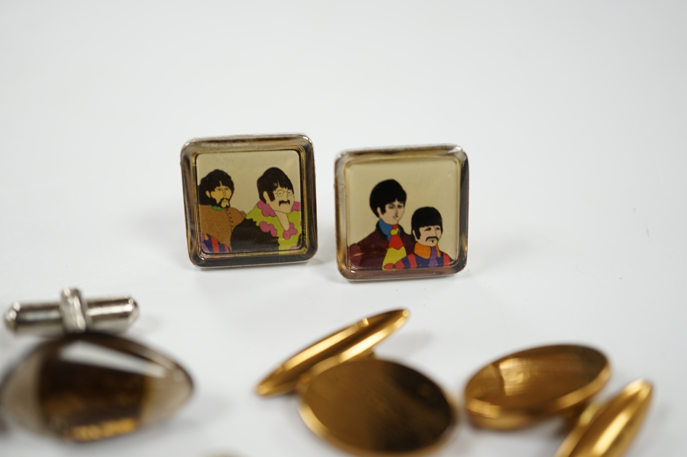 Four assorted pairs of gilt or base metal cufflinks including 'The Beatles'.